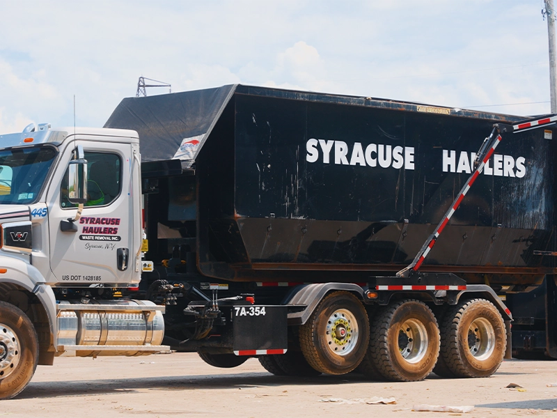 syracuse haulers roll off container on the back of a truck